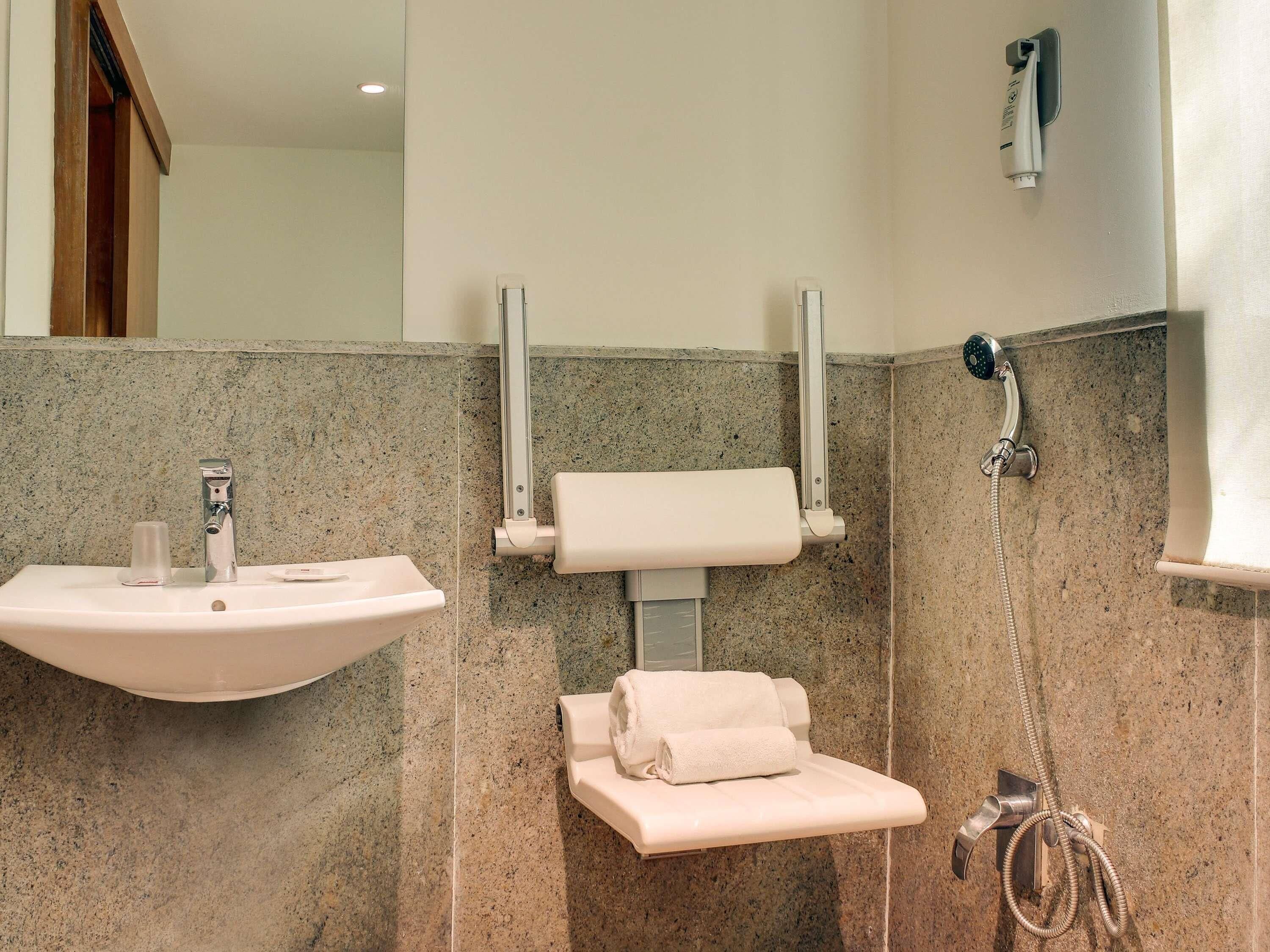 A bathroom with a sink, toilet, and shower.