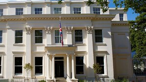 A stately building with a symmetrical facade, large windows, and a central entrance with steps leading up to it. - Malmaison Cheltenham (Cheltenham)