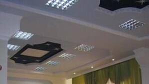 A conference room with long tables and chairs, a whiteboard, and a green curtain. - Hotel Volter (Lviv)