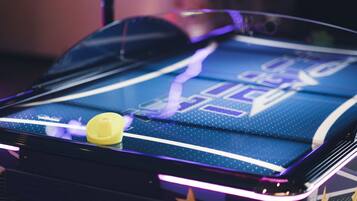 A close-up of a pinball machine with a star design and a yellow bumper.