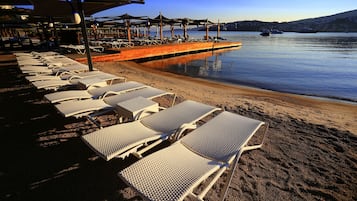 Private beach, free beach shuttle, free beach cabanas, beach umbrellas