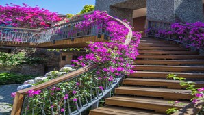 A wooden staircase with metal railings, surrounded by vibrant pink flowers. - Costa Farilya Special Class Hotel Bodrum - Special Class (Bodrum)