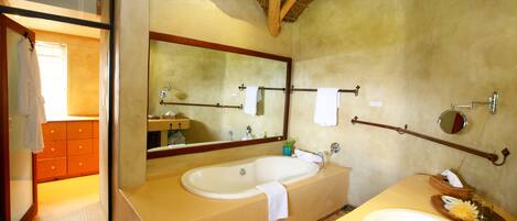 A bathroom with a wooden ceiling, two sinks, a large mirror, and a wooden vanity.