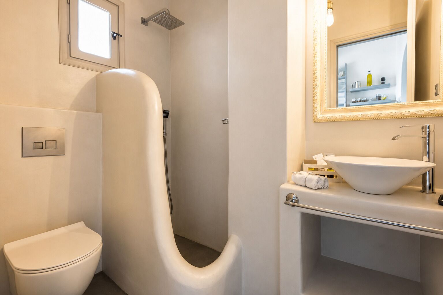 Un baño moderno con inodoro, ducha e lavamanos con espejo.