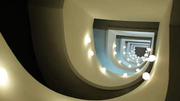 Una escalera de caracol con lámparas circulares.