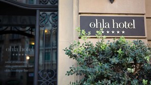 A hotel sign with the name "ohla hotel" and a rating of five stars.