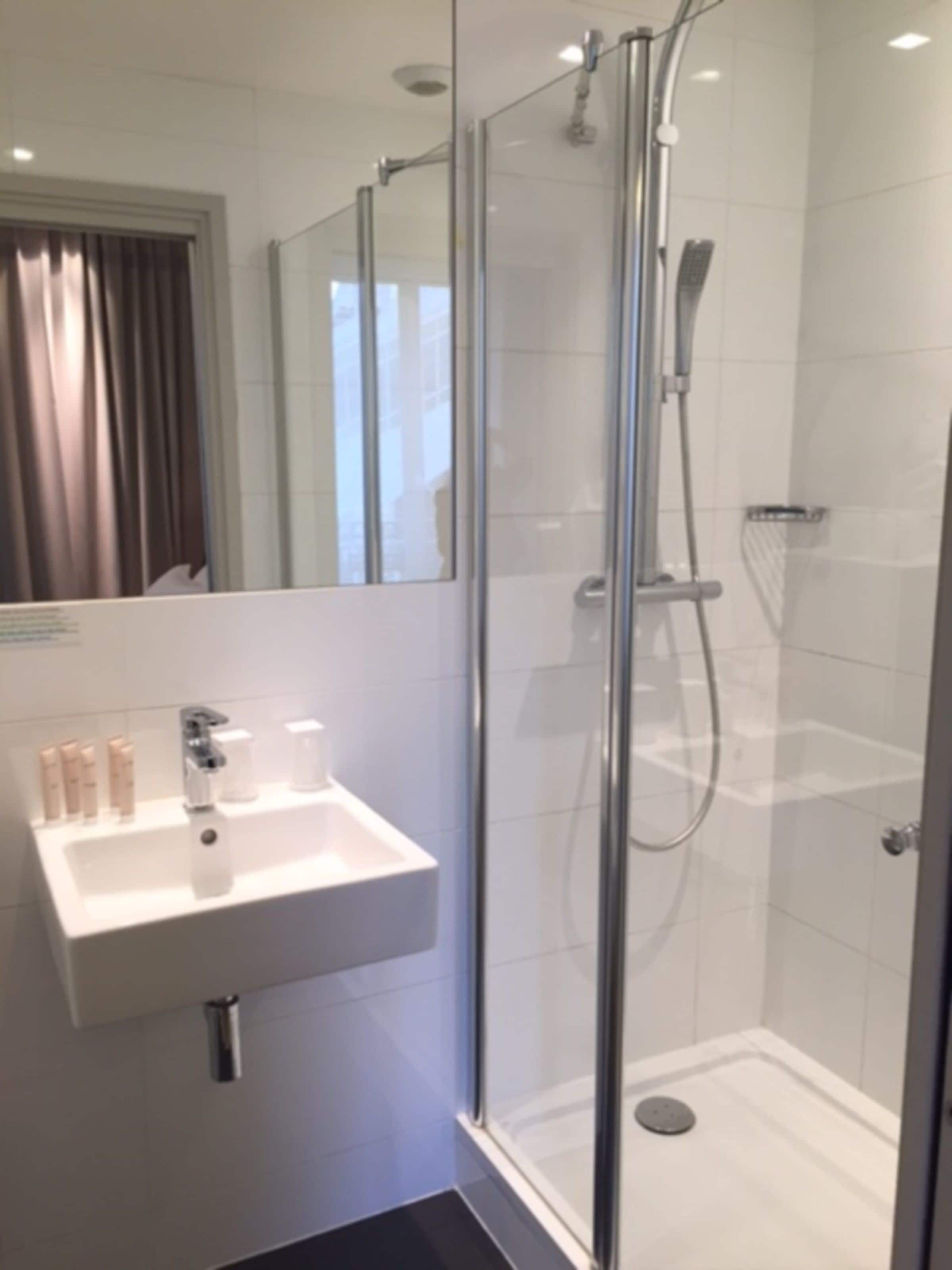 shower, rainfall showerhead, hair dryer, towels