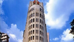 A tall, cylindrical building with a rounded top and arched windows. - Aiqun Hotel Guangzhou (Guangzhou)