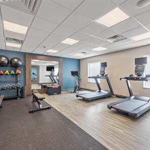 A gym with treadmills, a weight bench, kettlebells, and exercise balls. - Hampton Inn & Suites Denison (Denison)