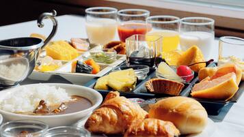A breakfast spread with various dishes and drinks on a table.