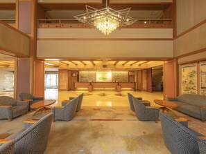 A spacious lobby with a reception desk, patterned seating, and a chandelier. - Hanabishi Hotel (Hakodate)