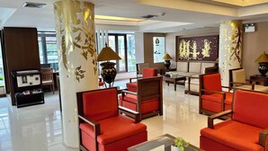 A hotel lobby with red armchairs, a coffee table, and decorative lamps. - Mariya Boutique Residence at Suvarnabhumi Airport (Bangkok)