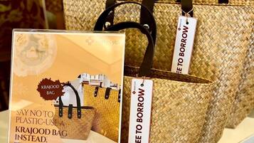 A display of woven bags with tags indicating they are free to borrow.