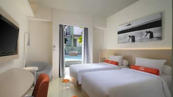 A hotel room with two beds, a TV, a desk, and a view of a pool and outdoor area.