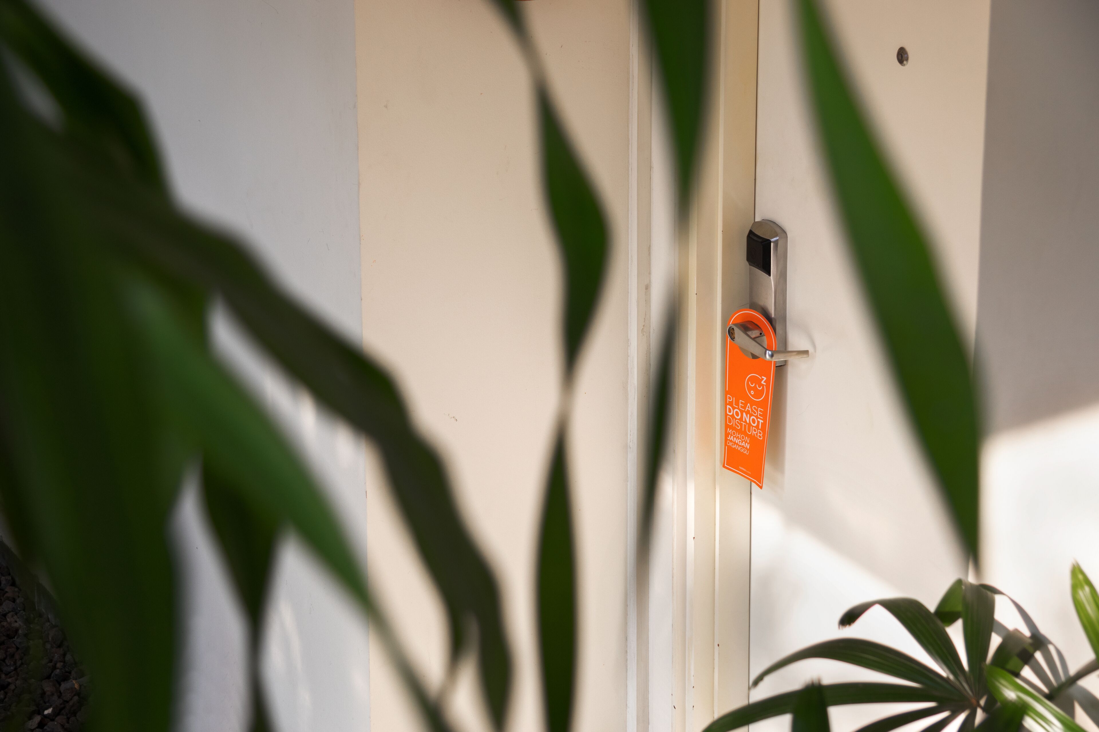 A door with a padlock and a sign that reads "Please do not disturb."