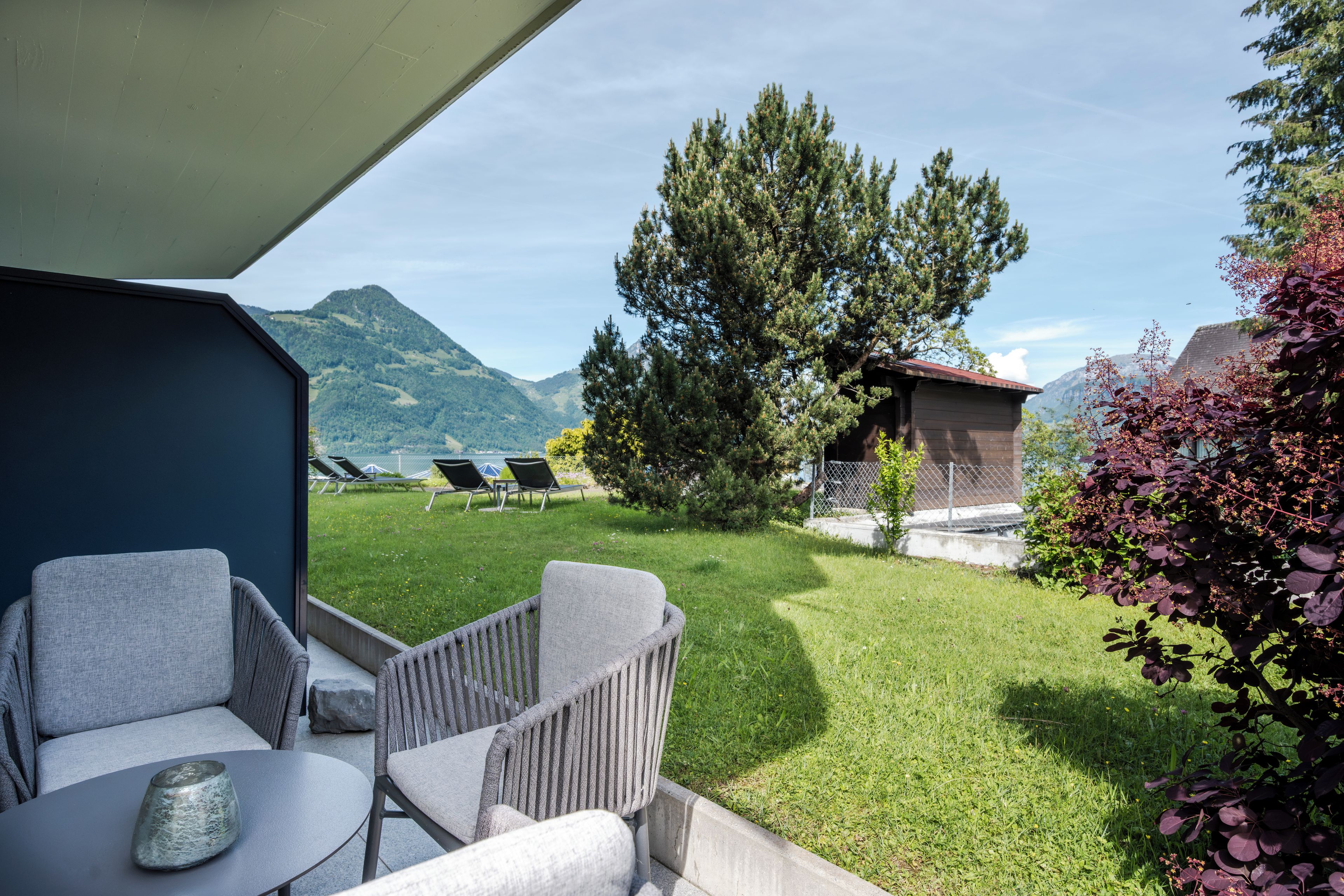 An outdoor seating area with a view of a mountain landscape.