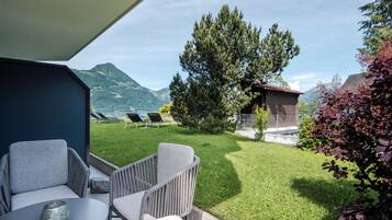 An outdoor seating area with a view of a mountain landscape.