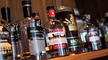 A variety of whisky bottles on a shelf.
