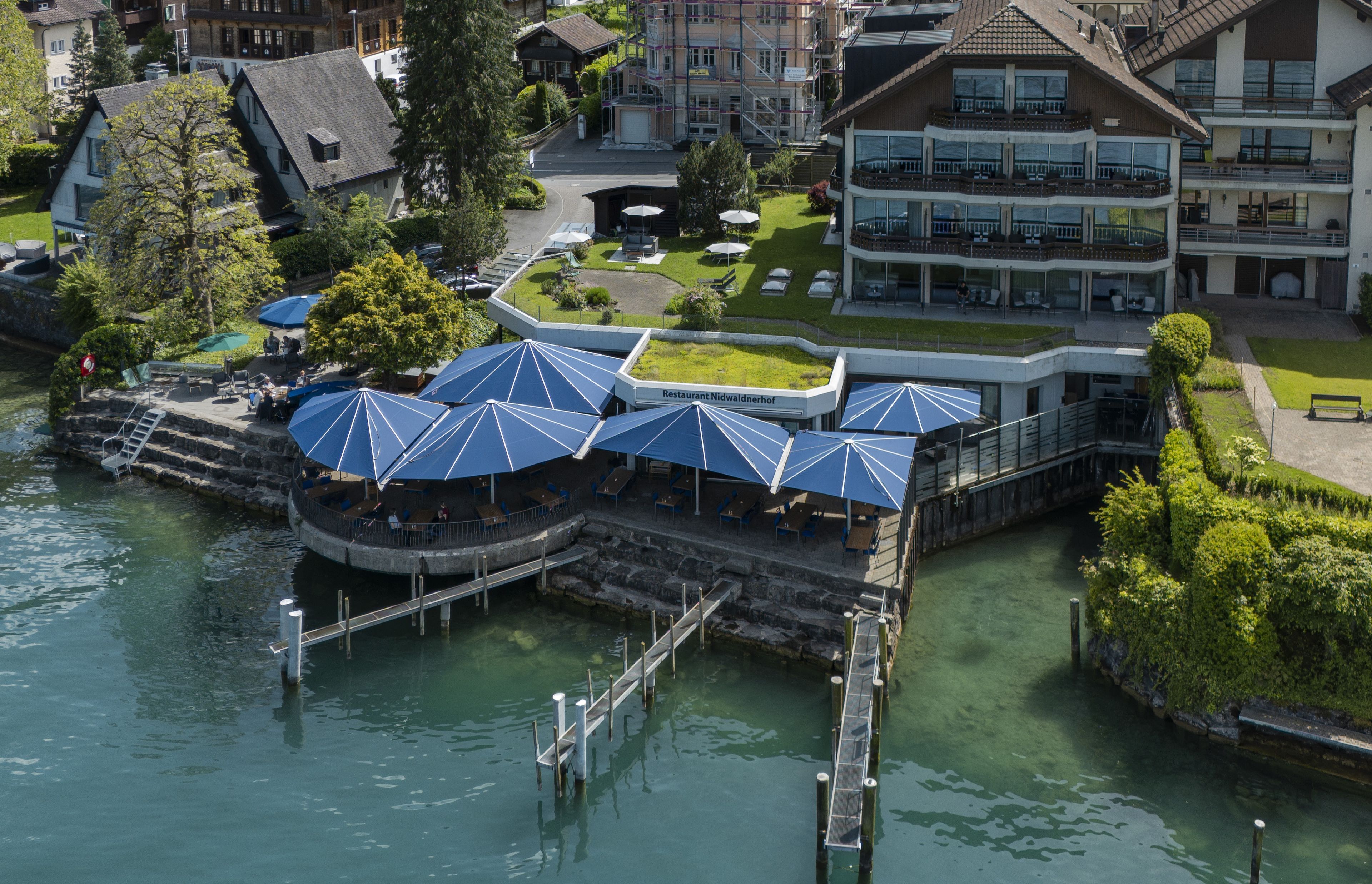 Un restaurant situé au bord de la rivière, avec une terrasse et un quai.