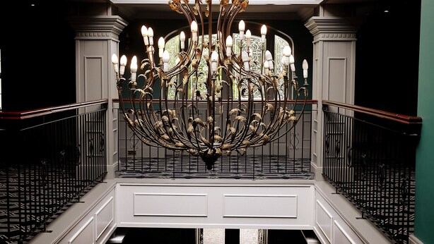 A grand chandelier in a spacious atrium with a high ceiling and patterned floor. - Racket Hall Country House (Roscrea)