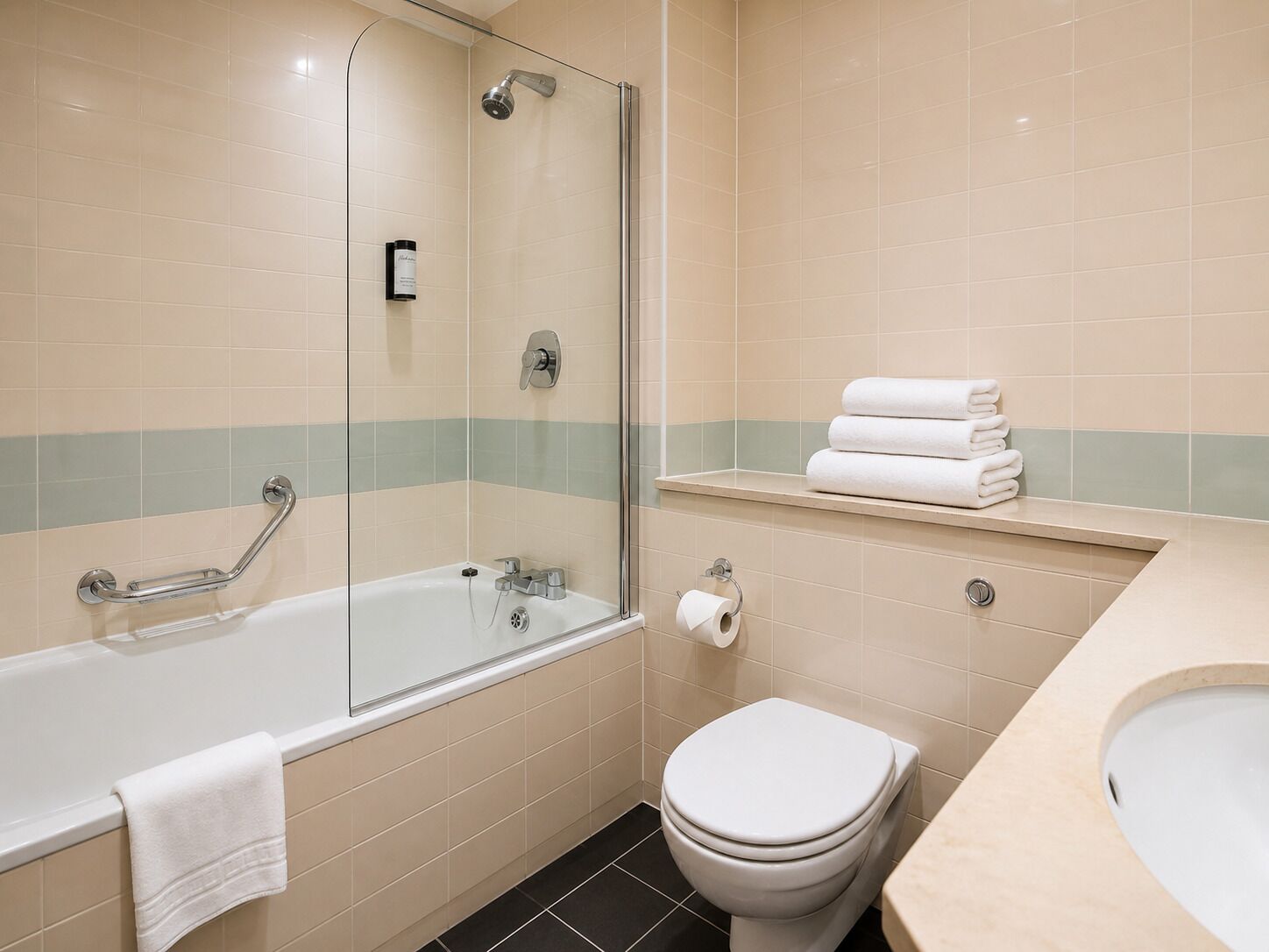 A bathroom with a glass-enclosed shower, a white toilet, a sink, and a towel rack.