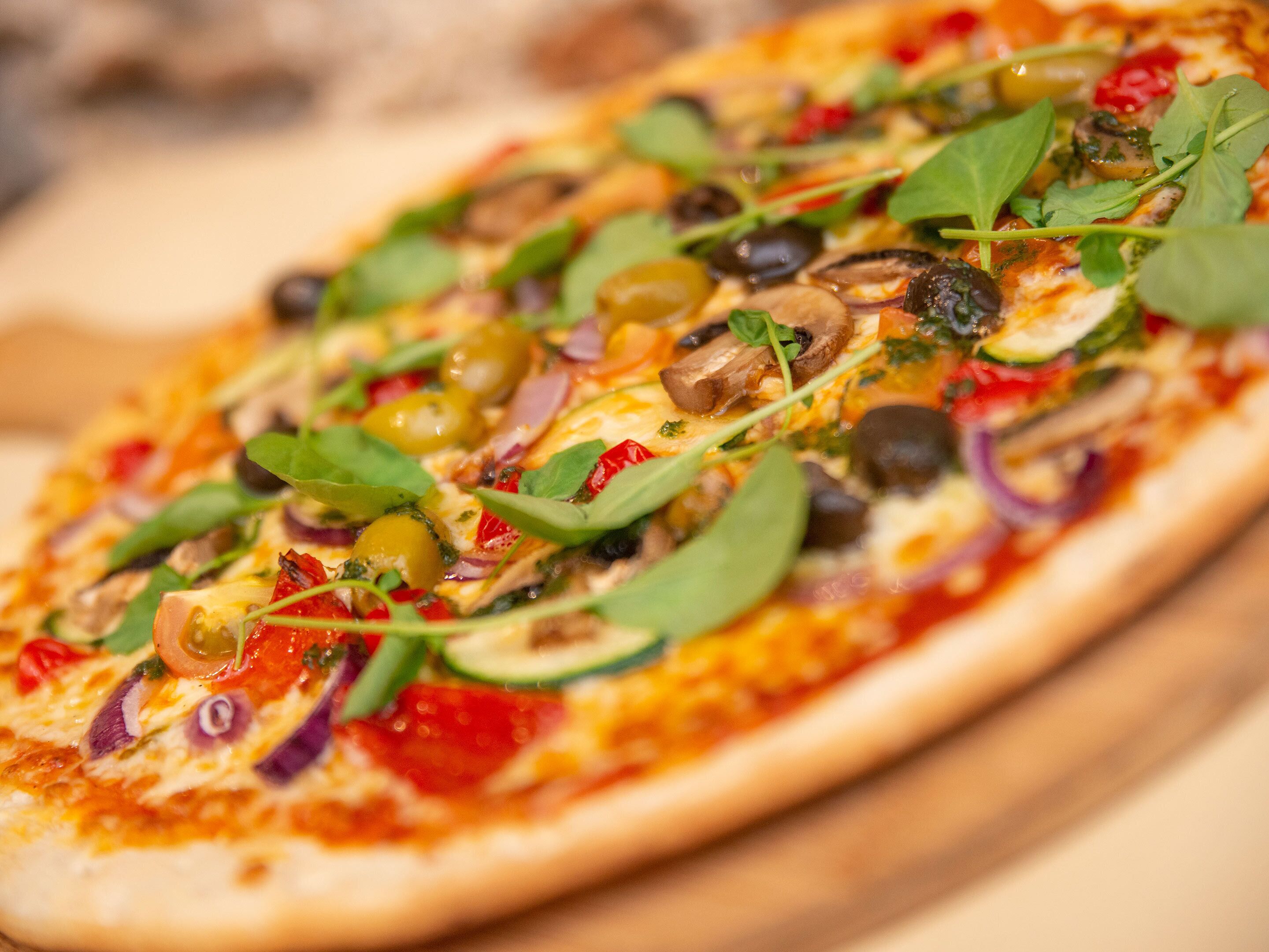 A pizza with various toppings.