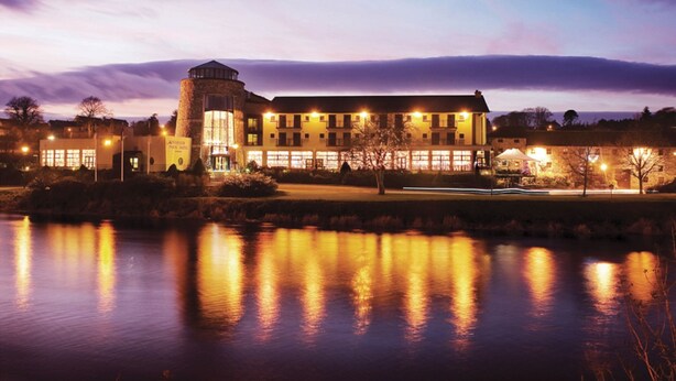 A large hotel with a central tower, multiple windows, and a reflection in the water. - Riverside Park Hotel and Leisure Club (Enniscorthy)