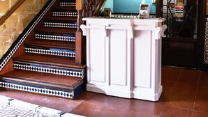 A staircase with patterned steps, a white column, and a blue wall. - El Caballo Blanco (Osuna)
