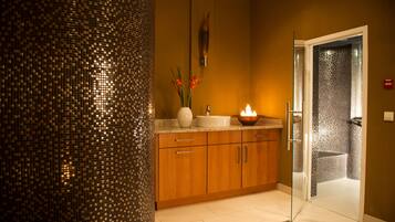 Contemporary bathroom with a mosaic wall, wooden vanity, and separate shower area.