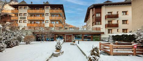 A hotel with multiple balconies and a snow-covered courtyard.