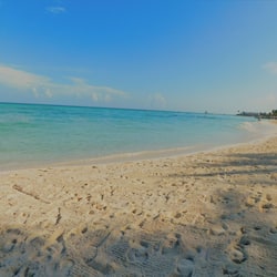 On the beach, white sand, sun loungers, beach umbrellas
