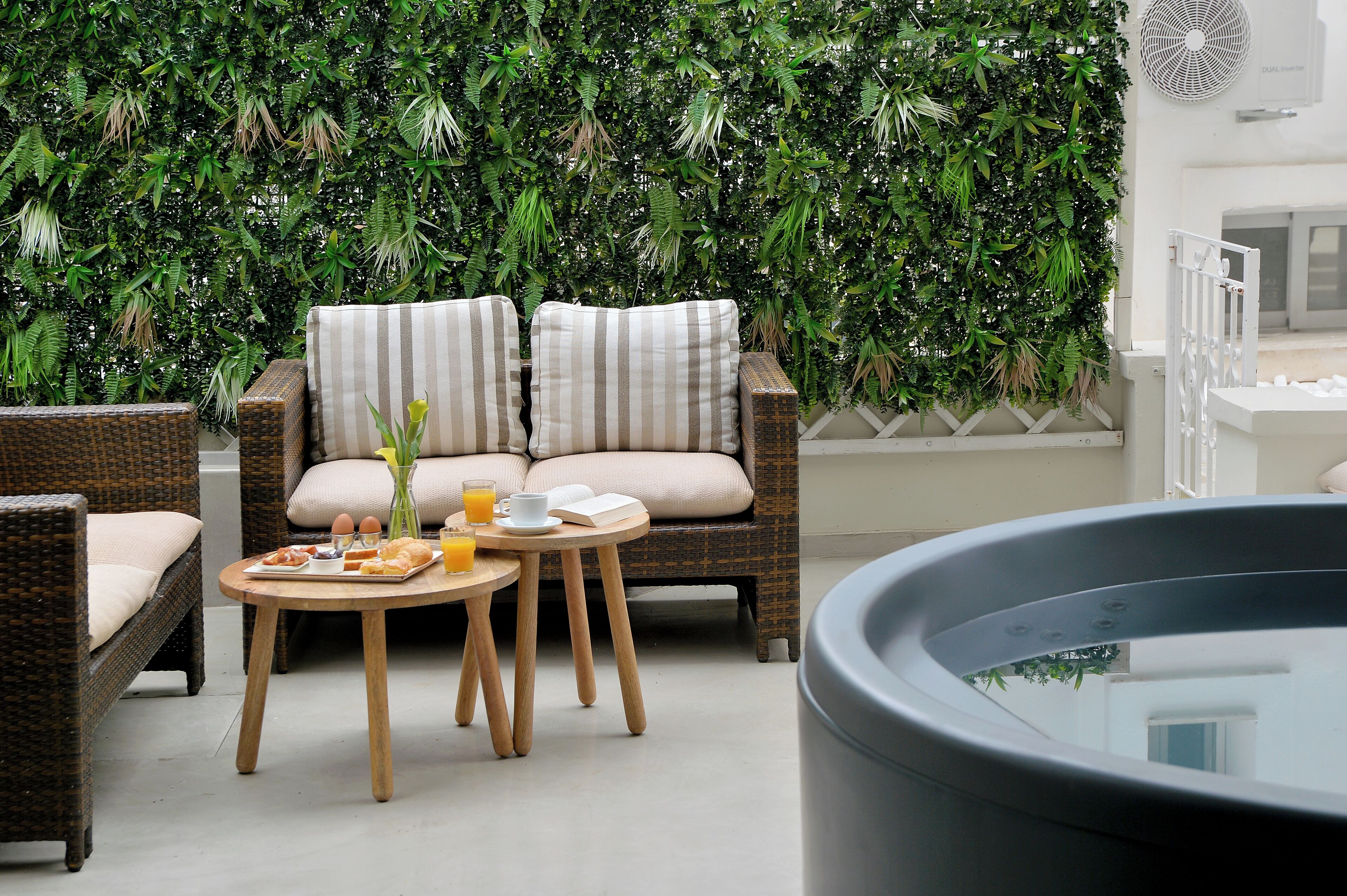 A cozy seating area with wicker furniture and a small table with breakfast items.