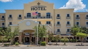 A hotel with a prominent sign, multiple balconies, and a flag.