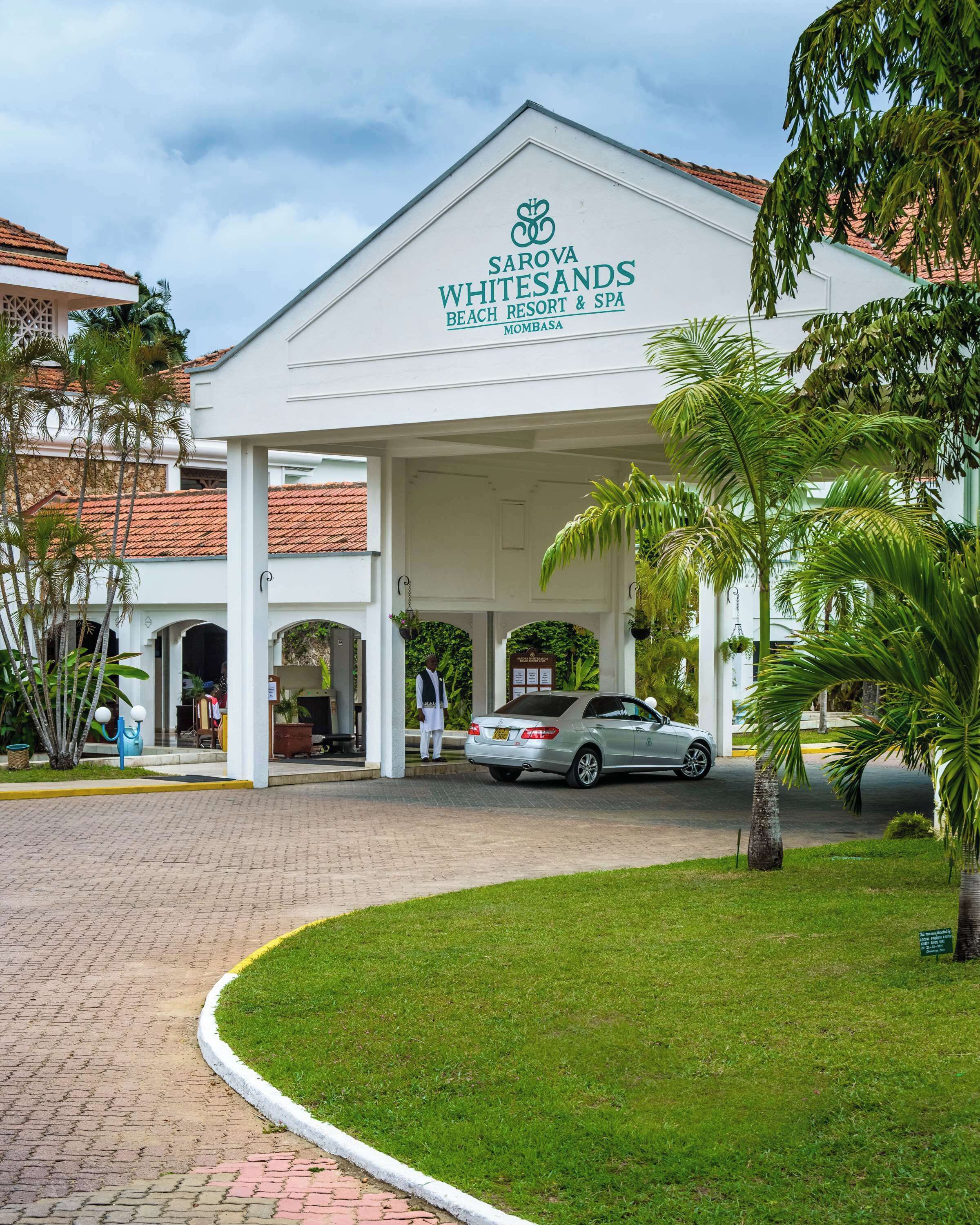 The entrance to Sarova Whitesands Beach Resort & Spa in Mombasa, featuring a covered entrance with a car parked in front.