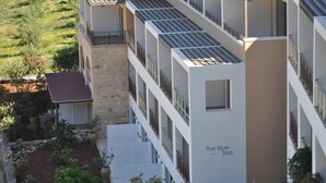 A multi-story hotel with a modern design, featuring balconies and a spa named "The Blue Spa". - Filion Suites Resort & Spa (Mylopotamos)