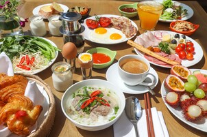 A table with various dishes including eggs, meat, vegetables, and a bowl of soup.