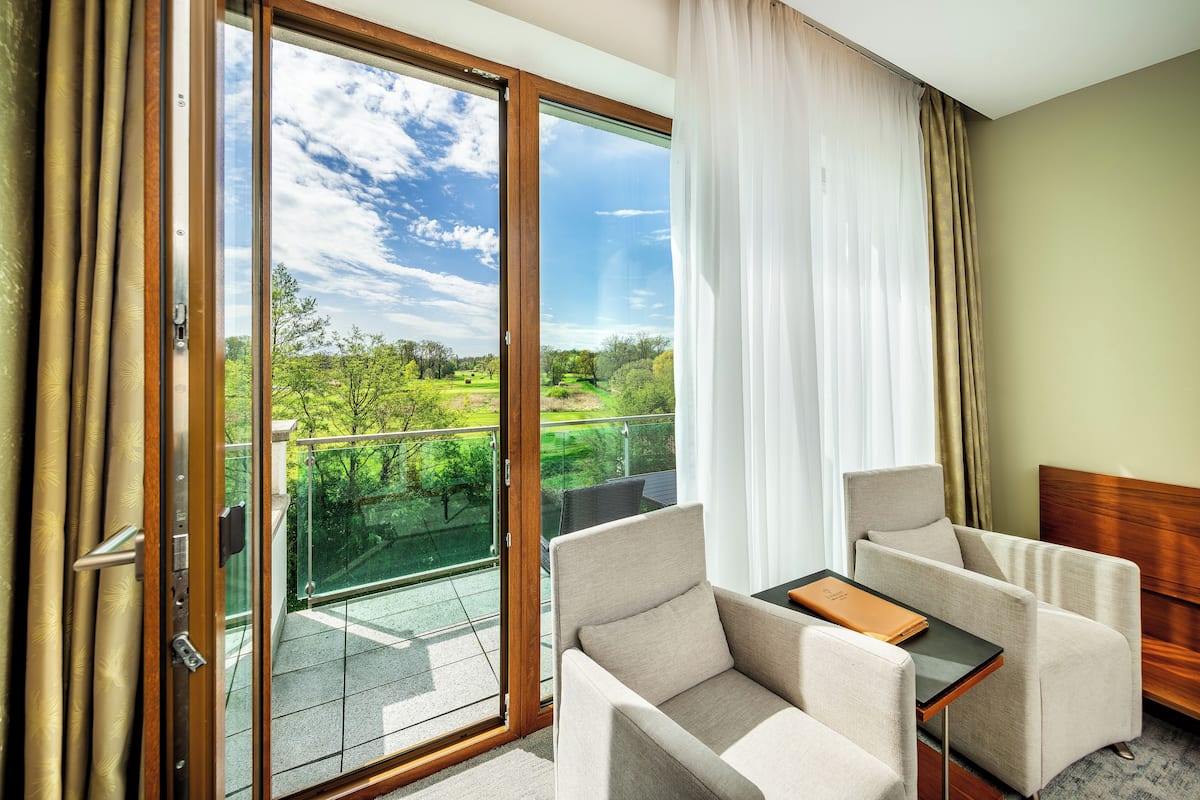 deluxe double room with golf course view and balcony | minibar, in-room safe, desk, blackout curtains