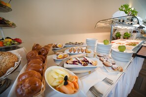 A buffet with various food items including pastries, fruits, and salads. - Wellness Hotel Diamant (Hluboka nad Vltavou)