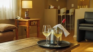 A room with a wooden table, two wine glasses, a bottle of wine, and a metal container. - SJ Jaguariaíva - San Juan Jaguariaíva (Jaguariaíva)