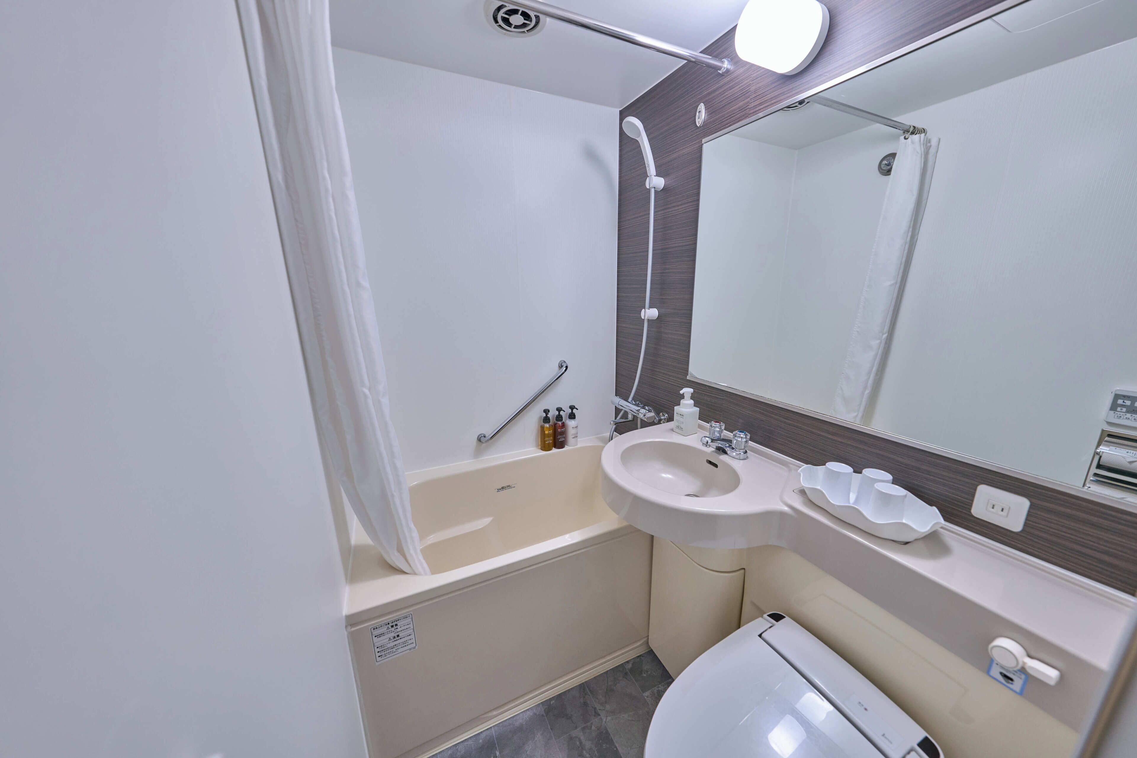 A modern bathroom with a bathtub, a sink, and a toilet.