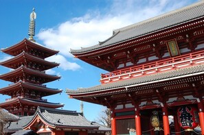 A traditional Japanese pagoda with multiple tiers and a red building with ornate details. - Smile Hotel Tokyo Nihonbashi (Tokyo)
