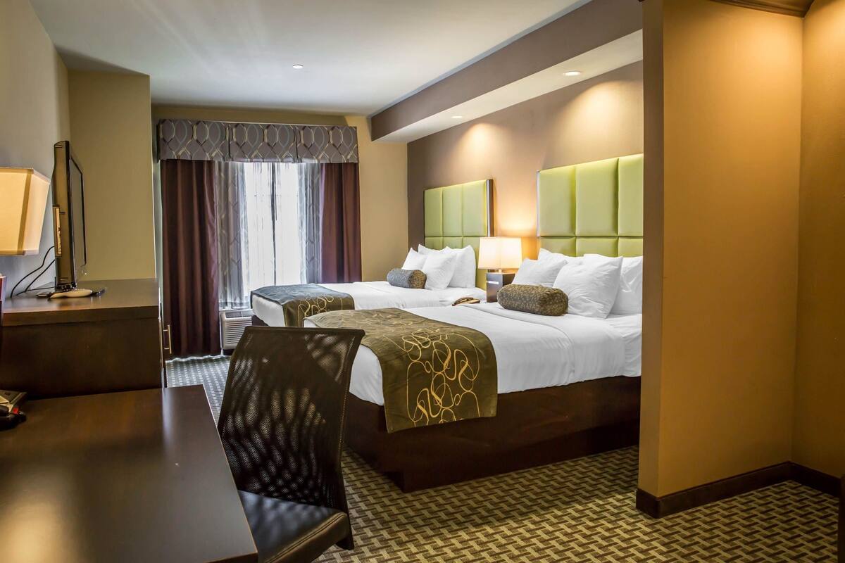 Une chambre d’hôtel avec un lit, un bureau et une chaise.
