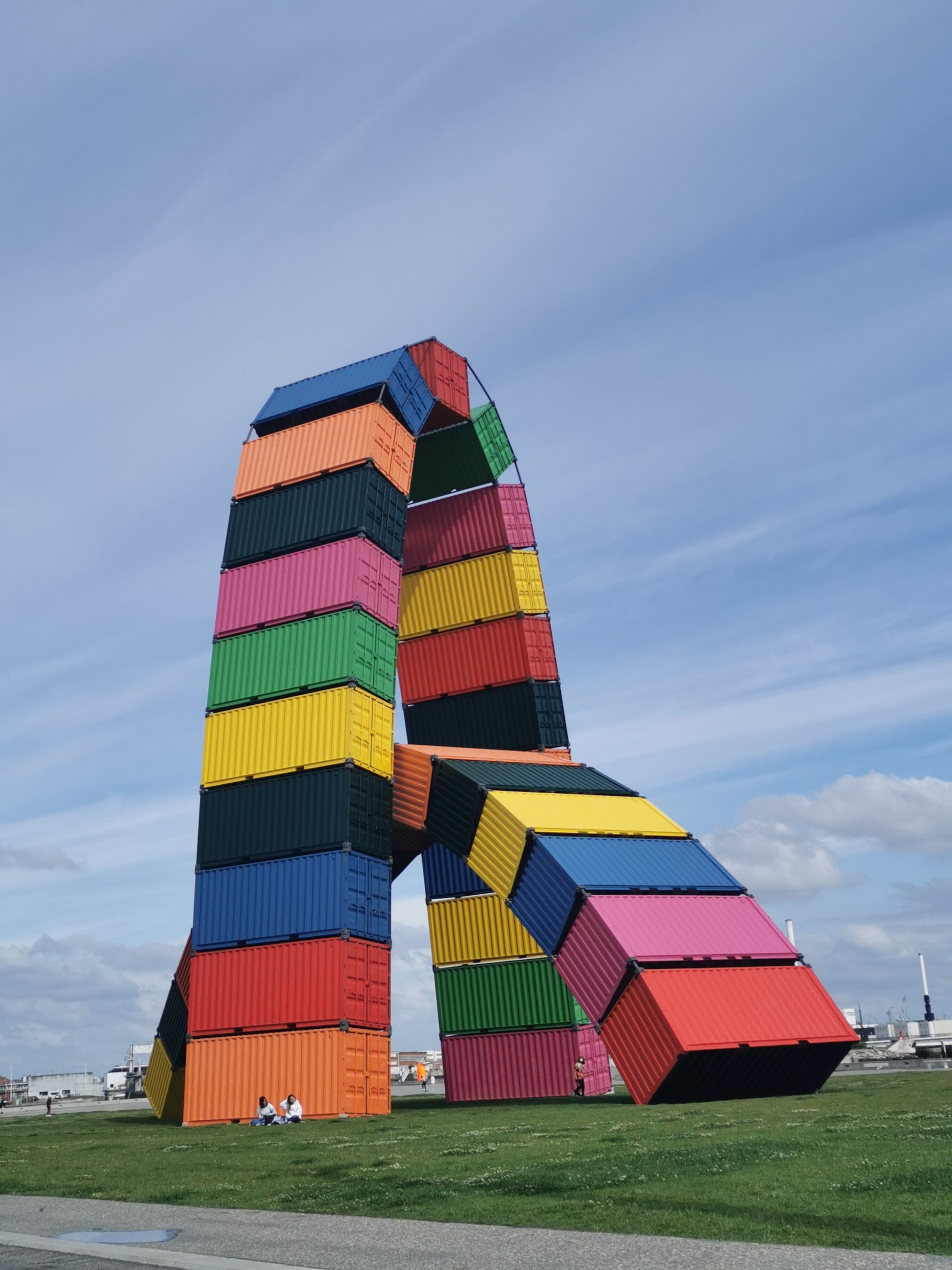 A colorful, abstract sculpture made of stacked shipping containers.