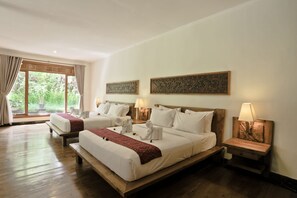 Two single beds with bedside tables and lamps, set against a backdrop of decorative panels and a large window.