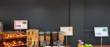 A breakfast buffet with various food items and condiments.