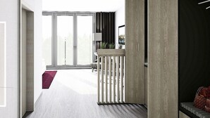 A modern interior with a large sliding glass door leading to a balcony, a seating area with a small table, and a dark-toned partition. - Hotel Rieth (Boeblingen)