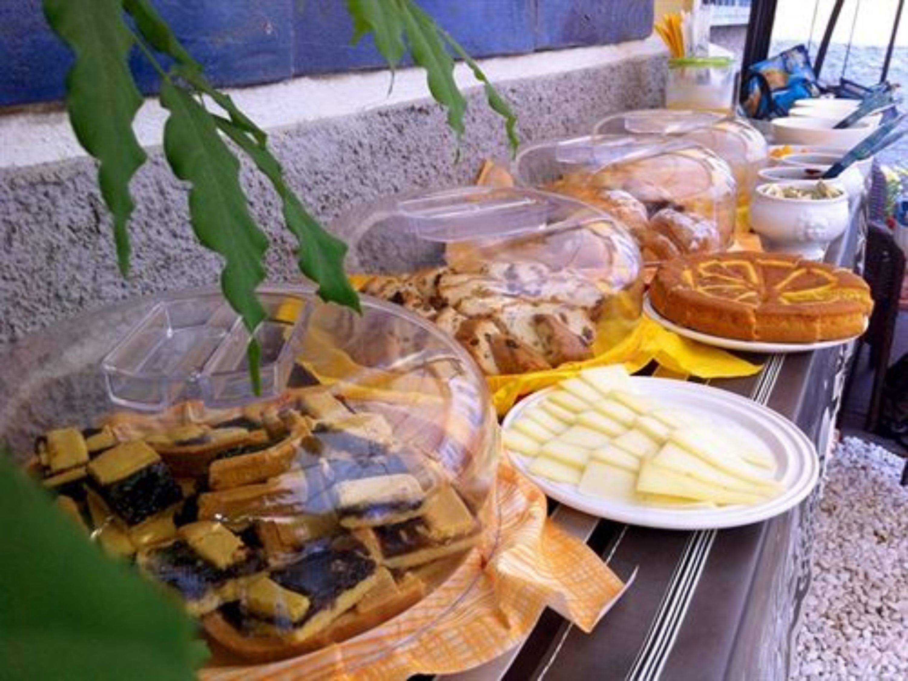 A buffet with various food items including bread, cheese, and other dishes.