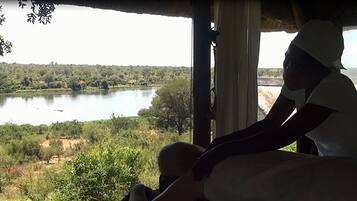 Enjoy breathtaking views of the surrounding landscape from this room's expansive window.