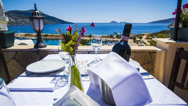 A table set for two with a view of the sea and mountains. - Kleo Pension (Kas)
