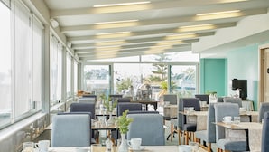 A modern cafe with tables and chairs arranged for dining.